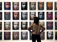 A wall of 32 woven portraits 