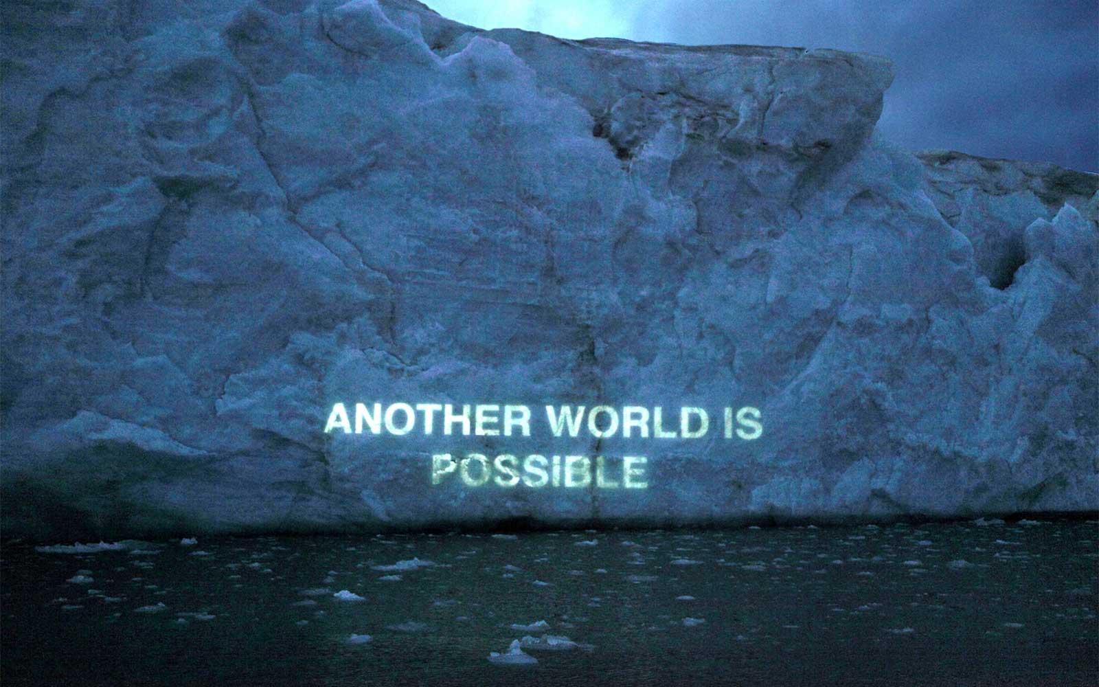 Another World is Possible, Ice Text projection, David Buckland.