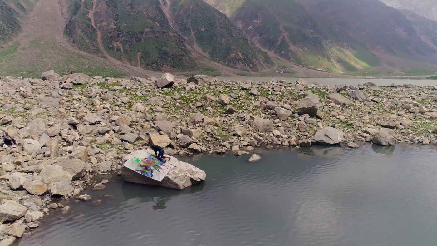 Nasser Azam painting on the rock, August 2018