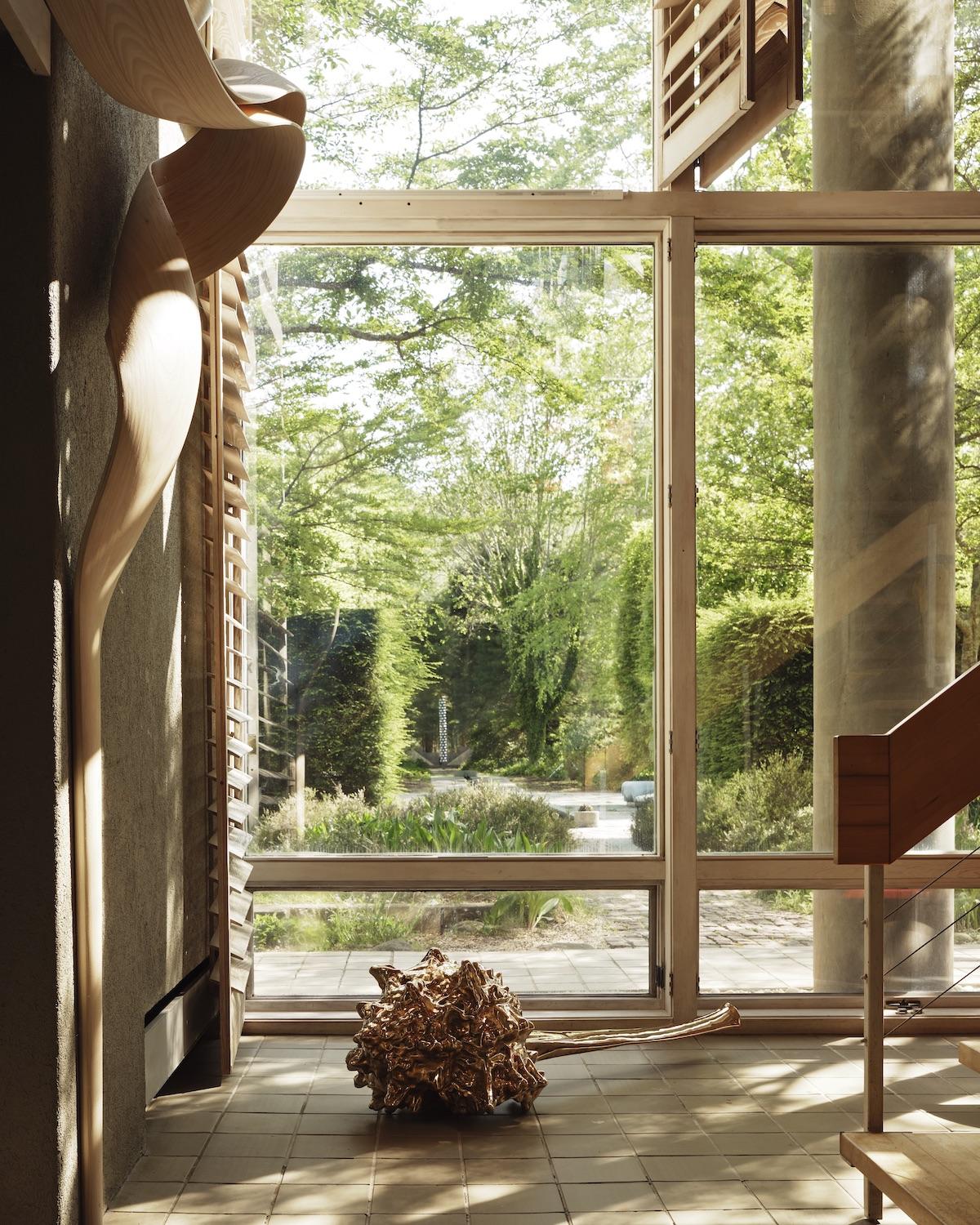 A Summer Arrangement: Object &amp; Thing at LongHouse. LongHouse, East Hampton, New York. Photo by Adrian Gaut. Works pictured: [floor] Alma Allen, Not Yet Titled, 2023; [left wall] a site-specific wall shelf by Joseph Walsh for LongHouse entitled Enignum Shelf XXXVI (2019).