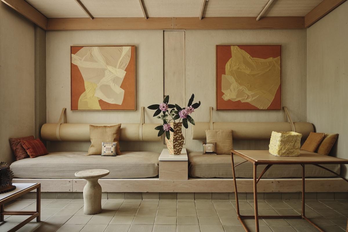 A Summer Arrangement: Object &amp; Thing at LongHouse. LongHouse, East Hampton, New York. Photo by Adrian Gaut. Works pictured: [left to right on wall] Megumi Shauna Arai, めぐりあ い II and めぐりあい III (2023); [on bed area] two hand-stitched pillows by Kiva Motnyk with pillows from the collection of LongHouse; Cody Hoyt, Untitled Vessel (Curved Walls 02) (2017); [foreground] Rashid Johnson, Untitled Ceramic (2019) on a table by Wharton Esherick from the collection at LongHouse.