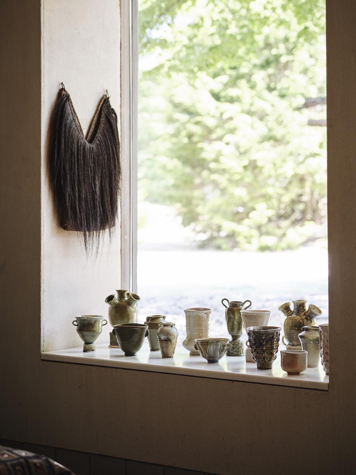 A Summer Arrangement: Object &amp; Thing at LongHouse. LongHouse, East Hampton, New York. Photo by Adrian Gaut. Works pictured: Wood fired ceramics by Frances Palmer arranged in the windowsill inspired by other displays at LongHouse.