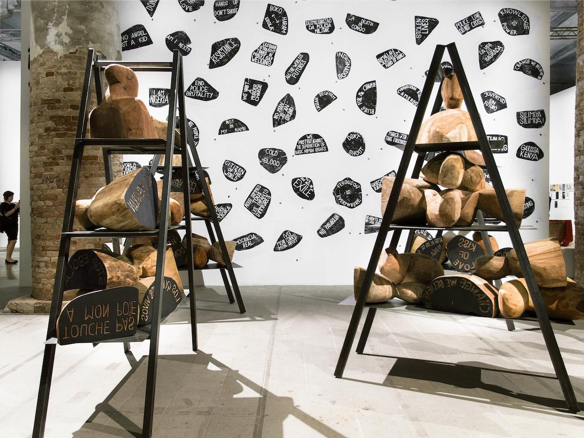 Barthélémy Toguo, Urban Requiem, 2015. Eight steel ladders, wooden stamps, wood block prints.