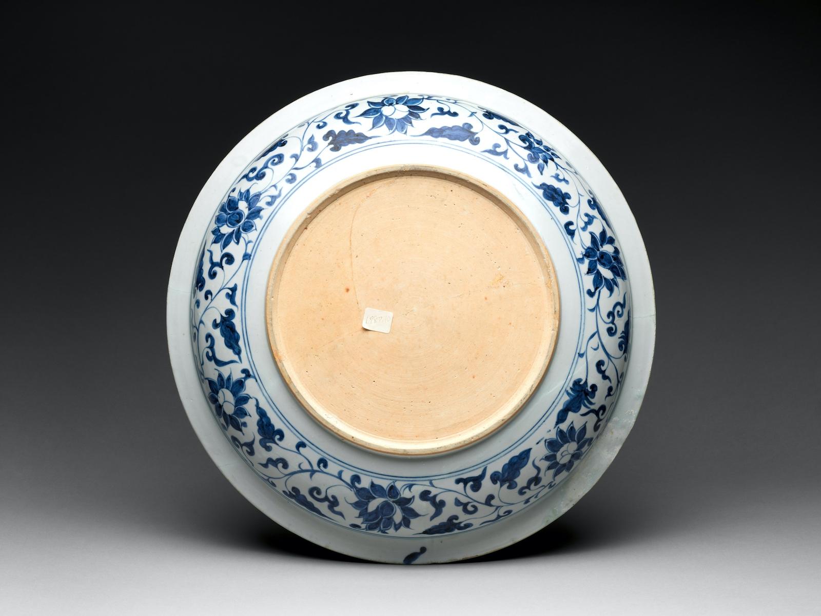 Bottom view of Plate with Carp. The sides are visible, detailed, and finished. The actual bottom is unfinished, unglazed.