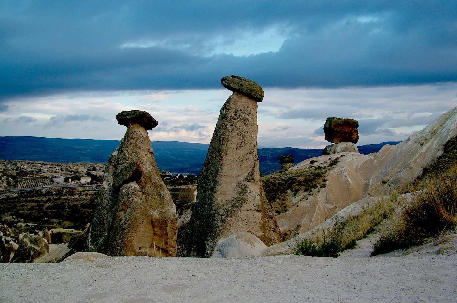 Fairy chimneys are tall, slim rocks capped by boulders that are created by erosion.