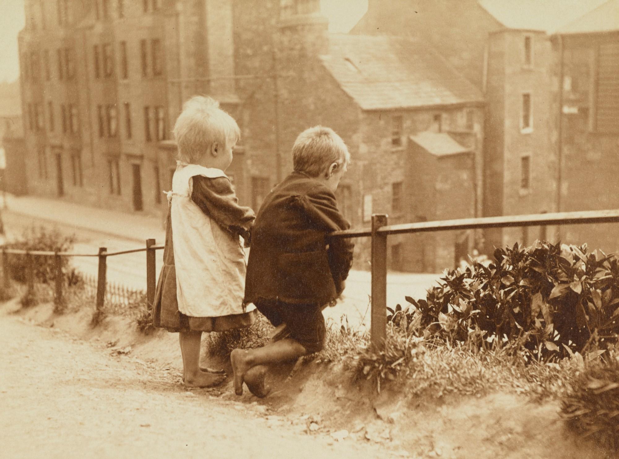 small children look down at a city block