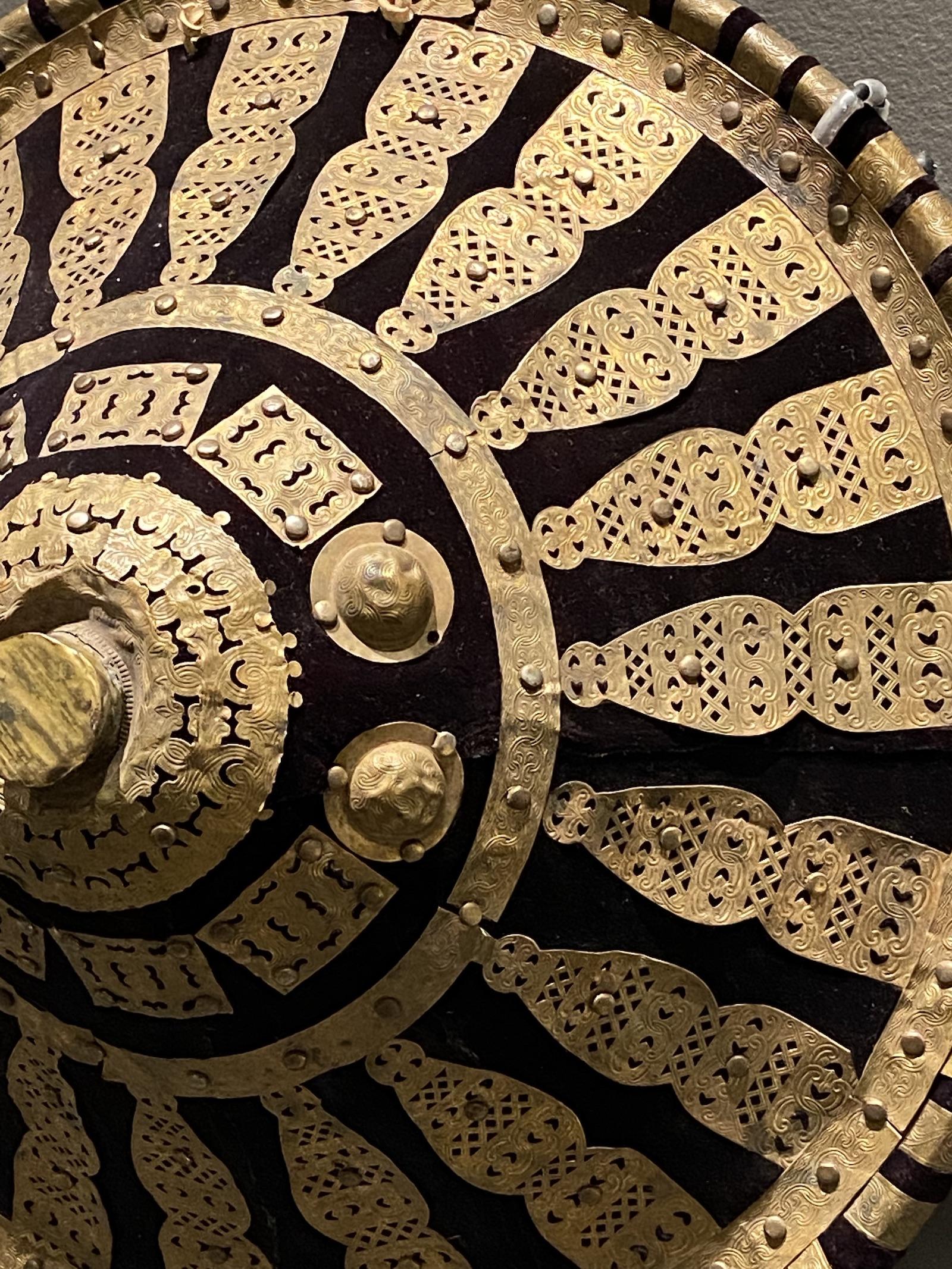 African Metalwork. Ethiopian artist, Ethiopia, Shield, 19th - 20th century. Brass, cloth, and animal hide. Collection of Drs. John and Nicole Dintenfass. Photo by Nia Bowers.