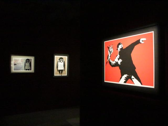 Installation view of Banksy: Genius or Vandal? featuring chimps and love is in the air
