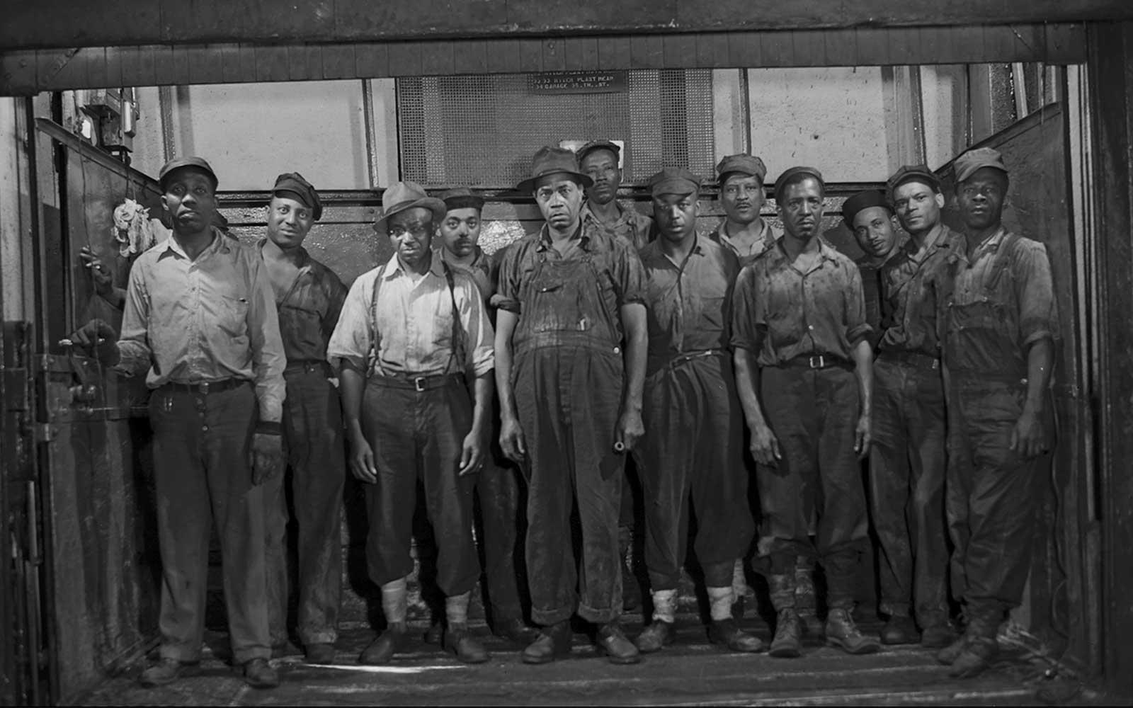 Gordon Parks, Grease makers and kettle tenders ascending by a freight lift to their working stations, September 1946.