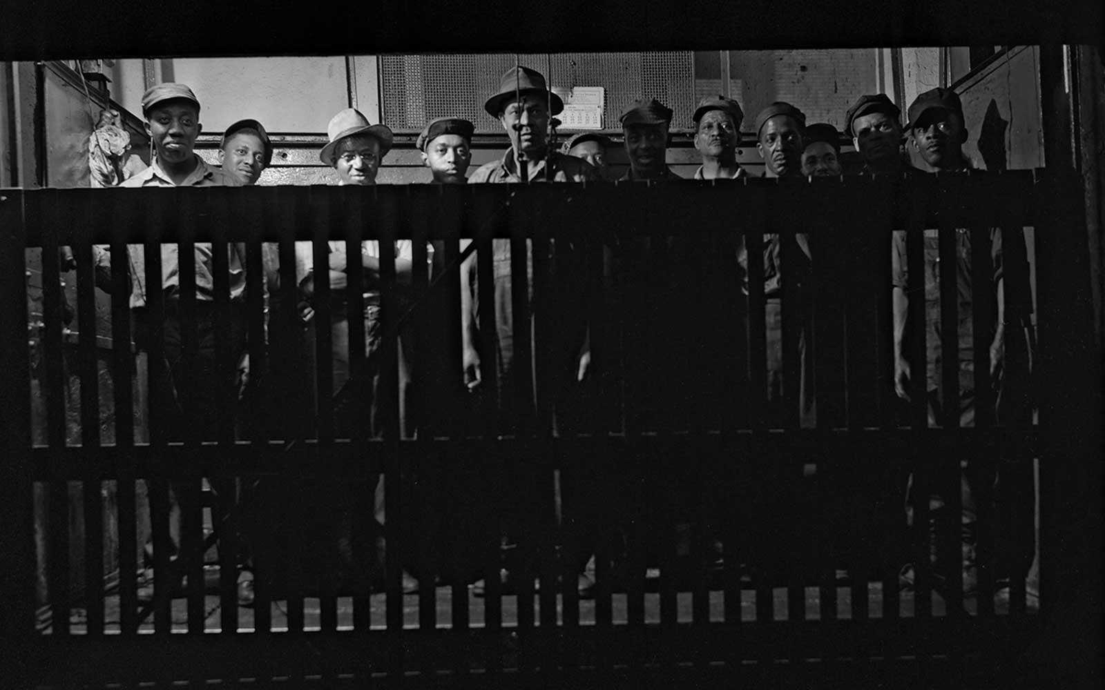 Gordon Parks, Grease makers and kettle tenders ascending by a freight lift to their work stations, September 1946.