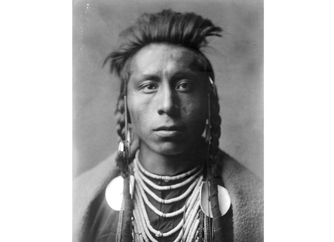 Lies Sideway. Head-and-shoulders portrait of Crow man, 1908.
