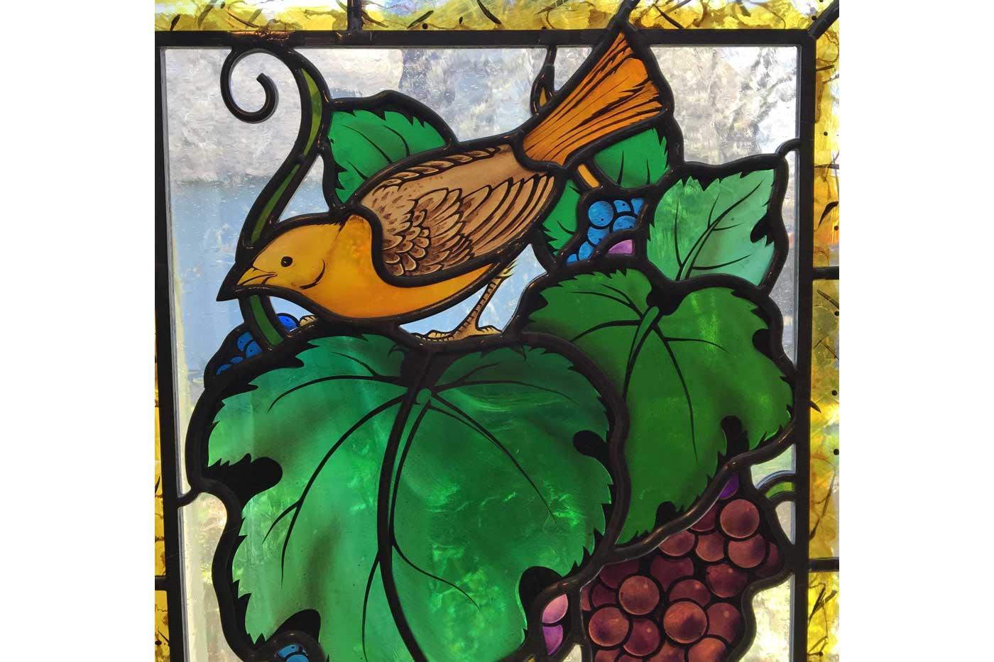 Stained glass painted by Indre McCraw beautifully accents Wolff's work.